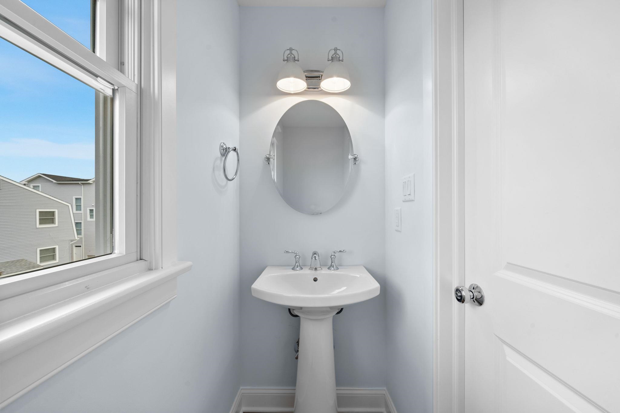 249 35th Street, Unit EAST SIDE Avalon, NJ 08202 - Photo 32 of 45 a bathroom with a sink and a mirror