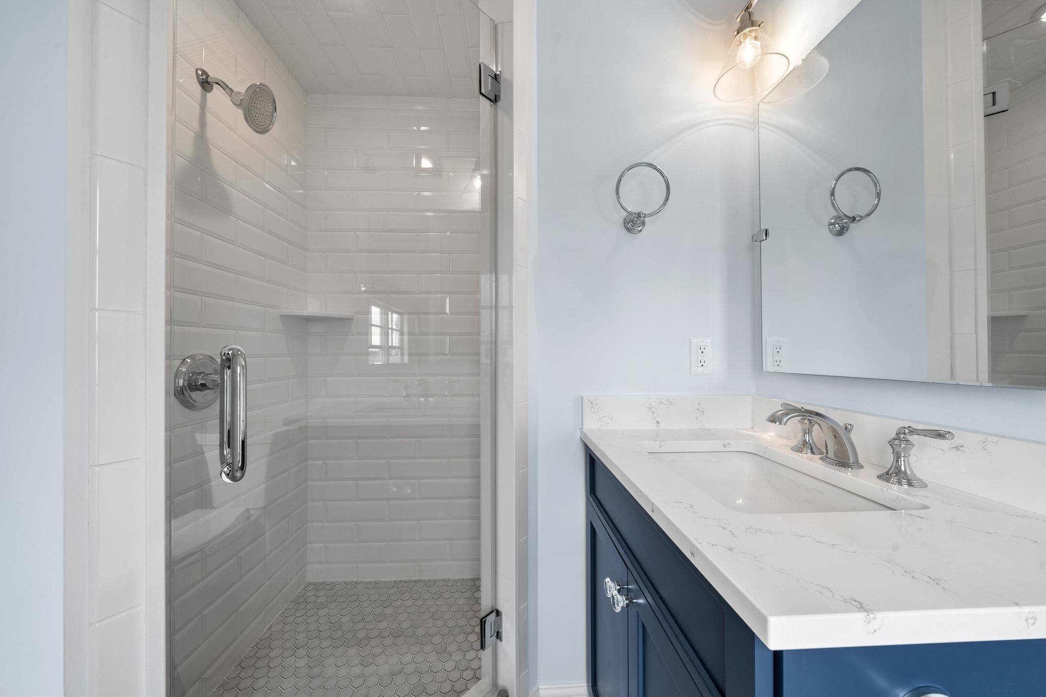 249 35th Street, Unit EAST SIDE Avalon, NJ 08202 - Photo 37 of 45 a bathroom with a granite countertop sink a shower and a mirror