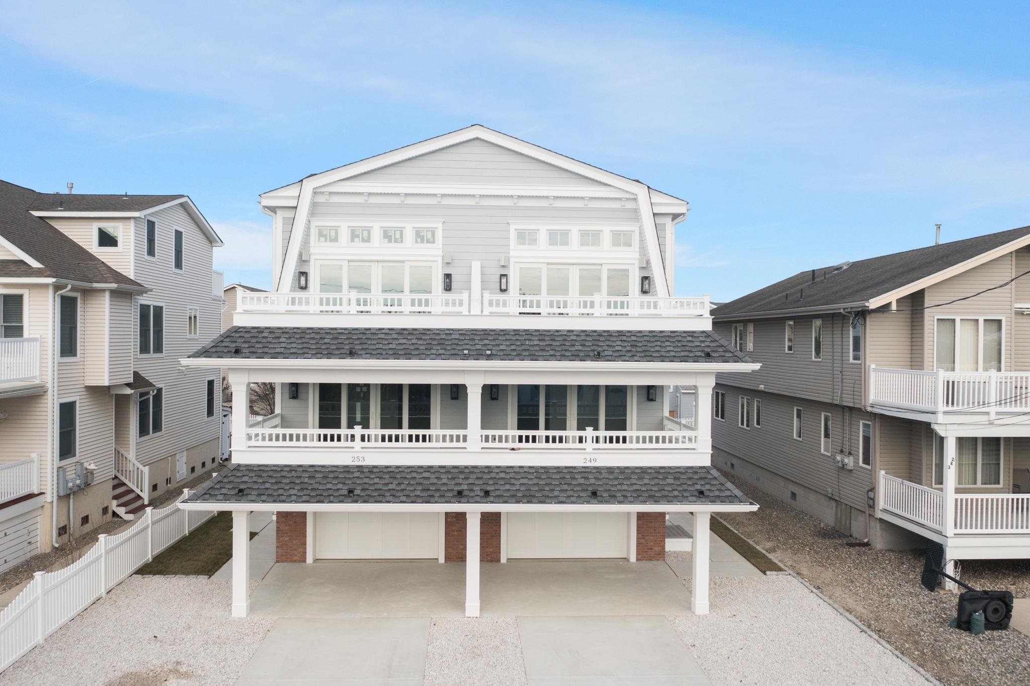 249 35th Street, Unit EAST SIDE Avalon, NJ 08202 - Photo 40 of 45 a view of a white building with a swimming pool