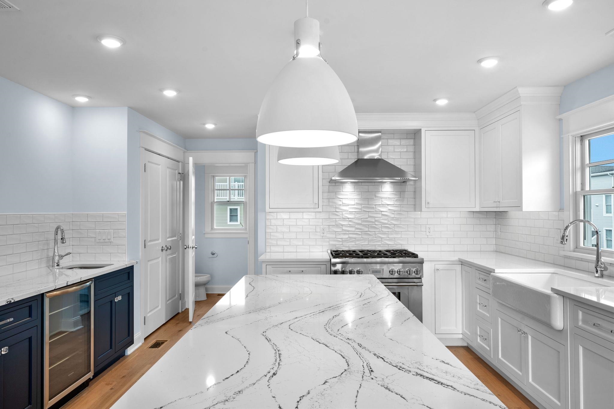 249 35th Street, Unit EAST SIDE Avalon, NJ 08202 - Photo 4 of 45 a kitchen with granite countertop a sink stainless steel appliances and cabinets