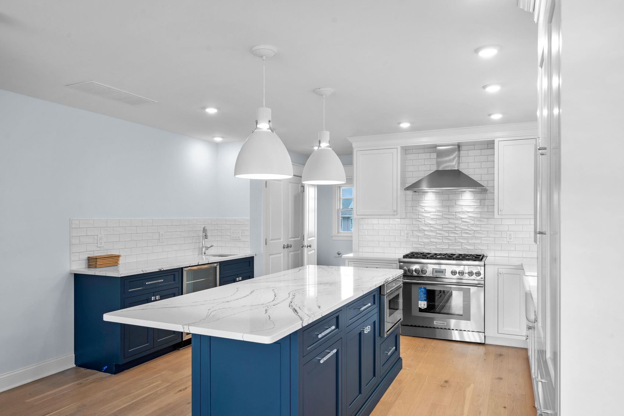 249 35th Street, Unit EAST SIDE Avalon, NJ 08202 - Photo 6 of 45 a large kitchen with stainless steel appliances a large counter top a stove and a sink