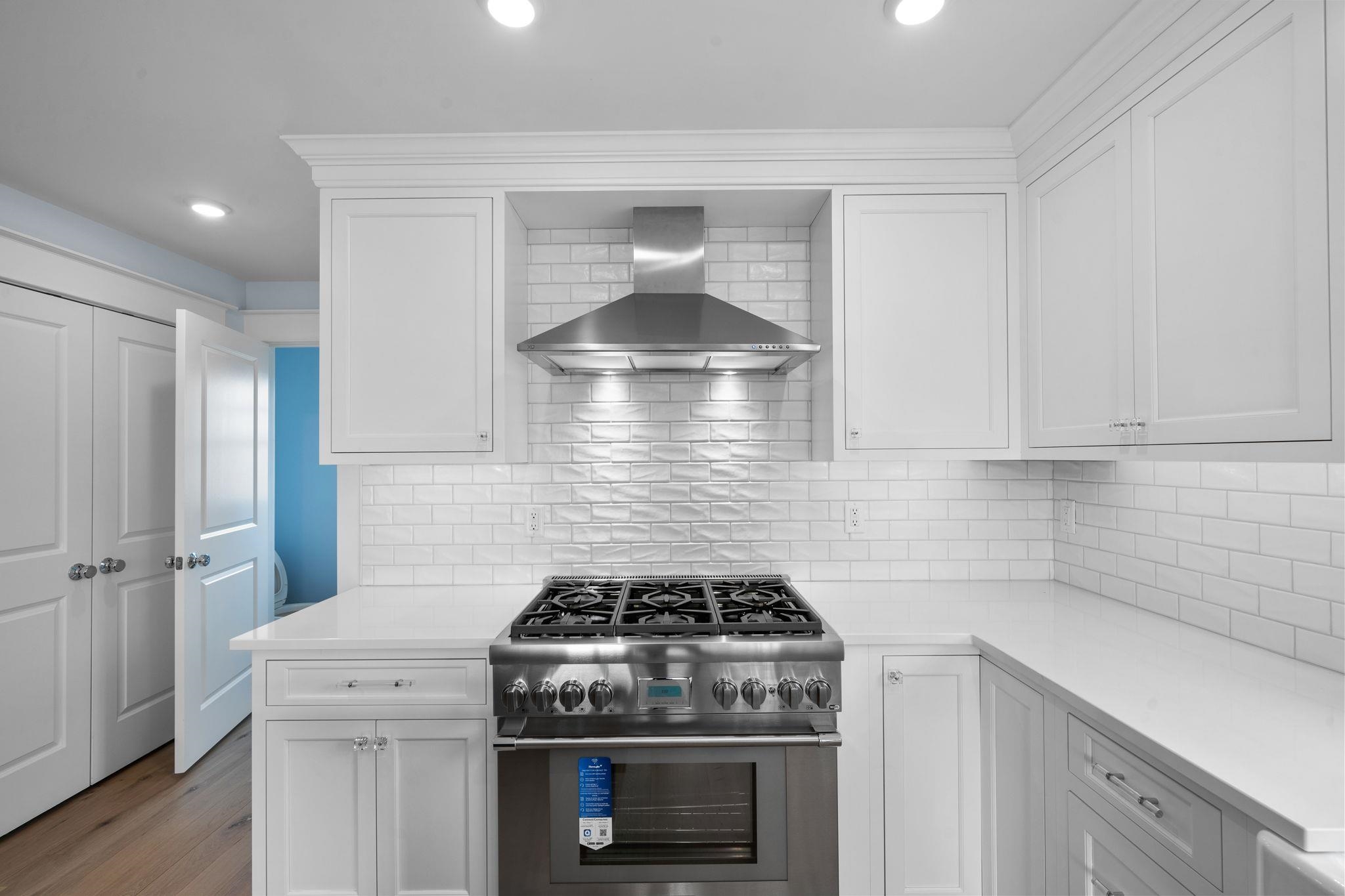 249 35th Street, Unit EAST SIDE Avalon, NJ 08202 - Photo 7 of 45 a kitchen with a stove and white cabinets