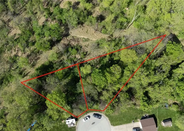an aerial view of a residential houses with yard