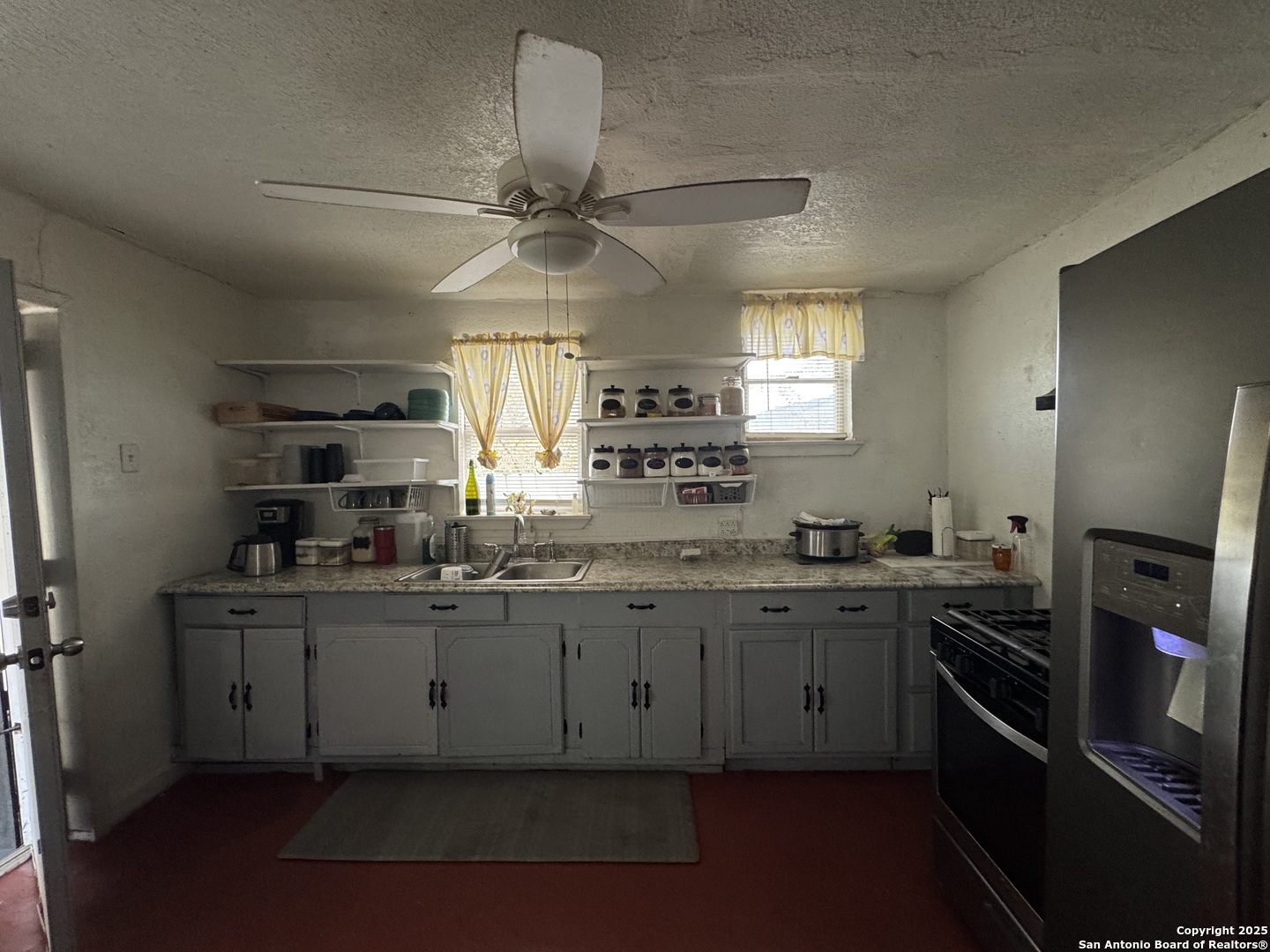 416 16th Street Hondo, TX 78861 - Photo 6 of 6 a kitchen with granite countertop a sink stainless steel appliances and cabinets
