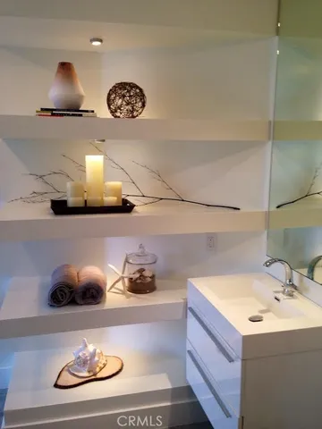 a bathroom with a sink and a wooden floor