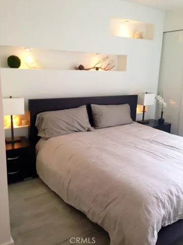 a large bed sitting in a bedroom next to a window