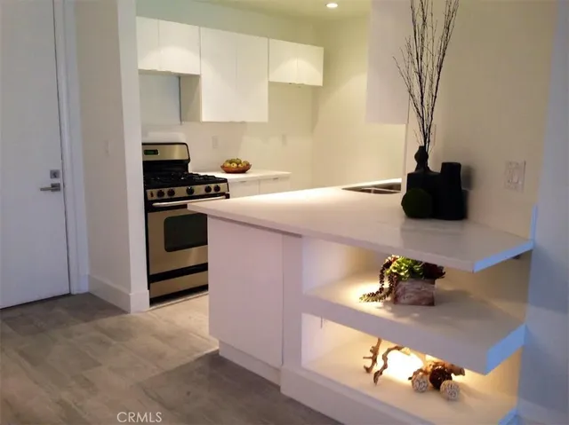 a kitchen with stainless steel appliances granite countertop a sink and a stove