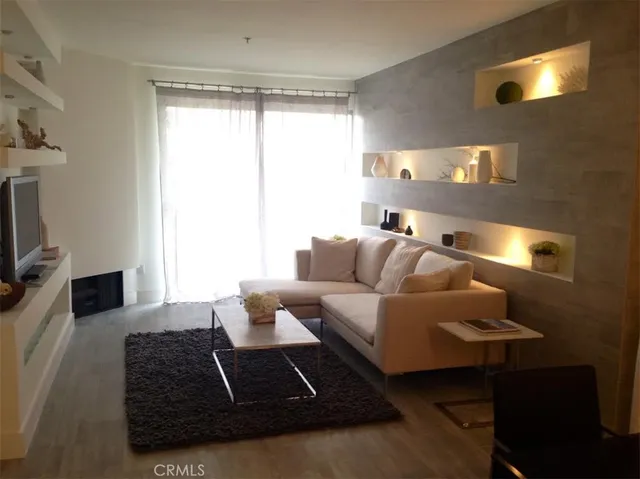 a living room with furniture rug and a large window