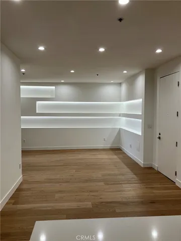 a view of a room with wooden floor