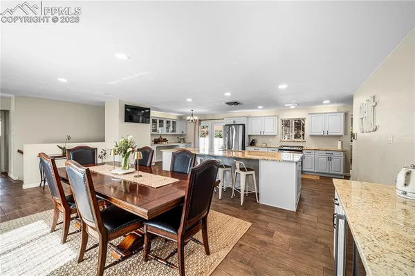 a view of a dining room with furniture and wooden floor
