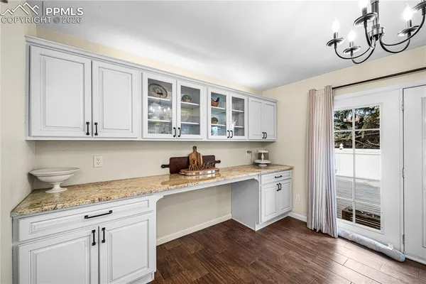 a kitchen with stainless steel appliances granite countertop a sink and cabinets with wooden floor