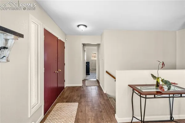 a hallway with table and flowerpot