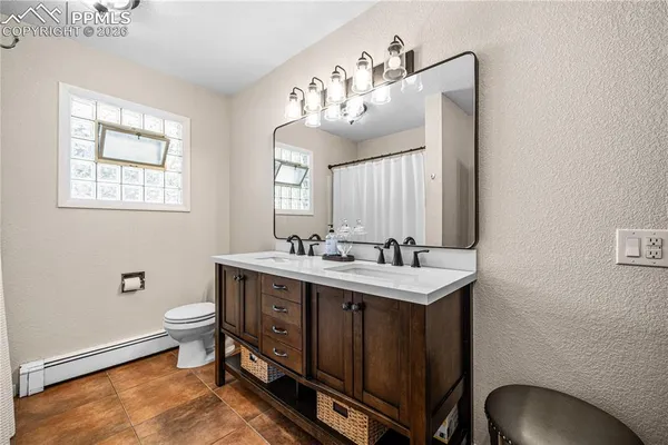 a bathroom with a sink vanity mirror and toilet