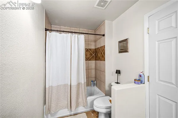 a white toilet sitting next to a bathroom sink