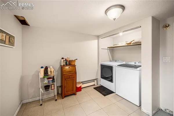 a bathroom with a granite countertop toilet a sink and a mirror