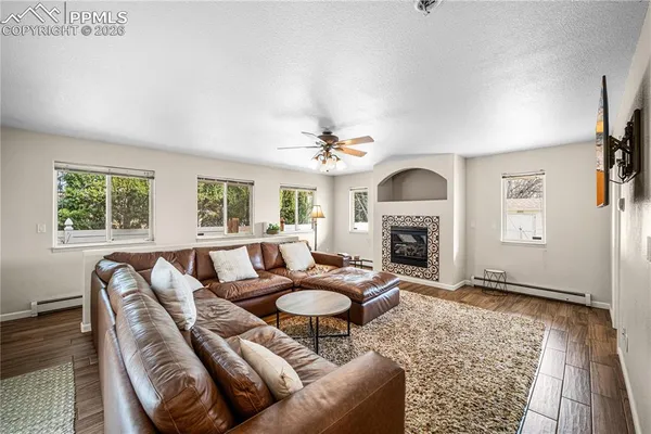 a living room with furniture a fireplace and a rug