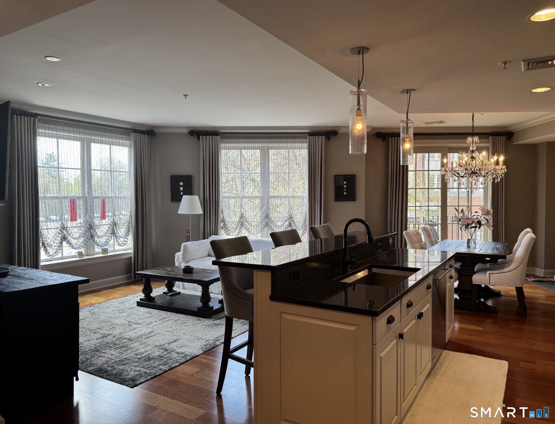 85 Memorial Road, Unit 201 West Hartford, CT 06107 - Photo 11 of 36 a kitchen with granite countertop a stove a sink a dining table and chairs