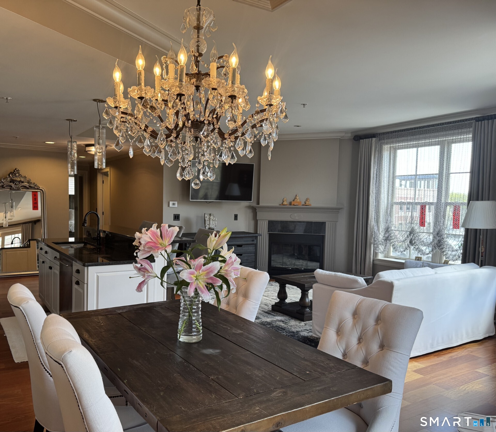 85 Memorial Road, Unit 201 West Hartford, CT 06107 - Photo 17 of 36 a living room with furniture a chandelier and a fireplace