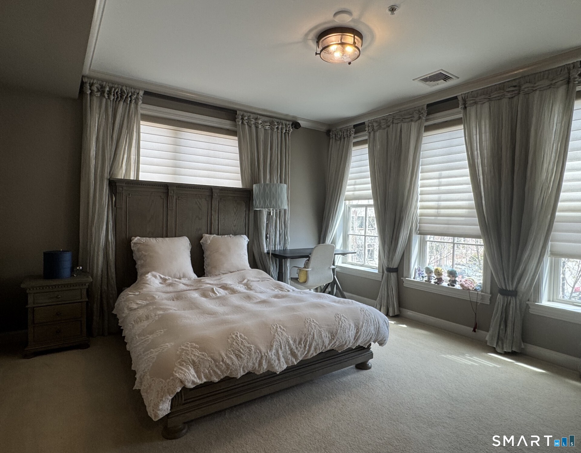 85 Memorial Road, Unit 201 West Hartford, CT 06107 - Photo 20 of 36 a large bed sitting in a bedroom next to a window