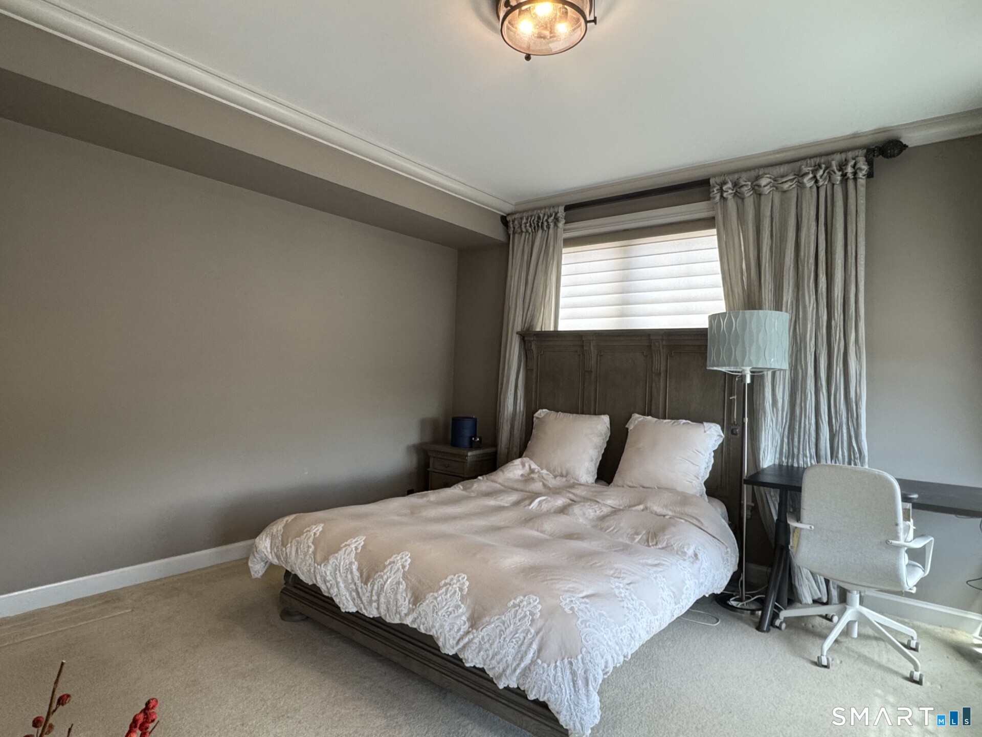 85 Memorial Road, Unit 201 West Hartford, CT 06107 - Photo 21 of 36 a bedroom with a bed and chair