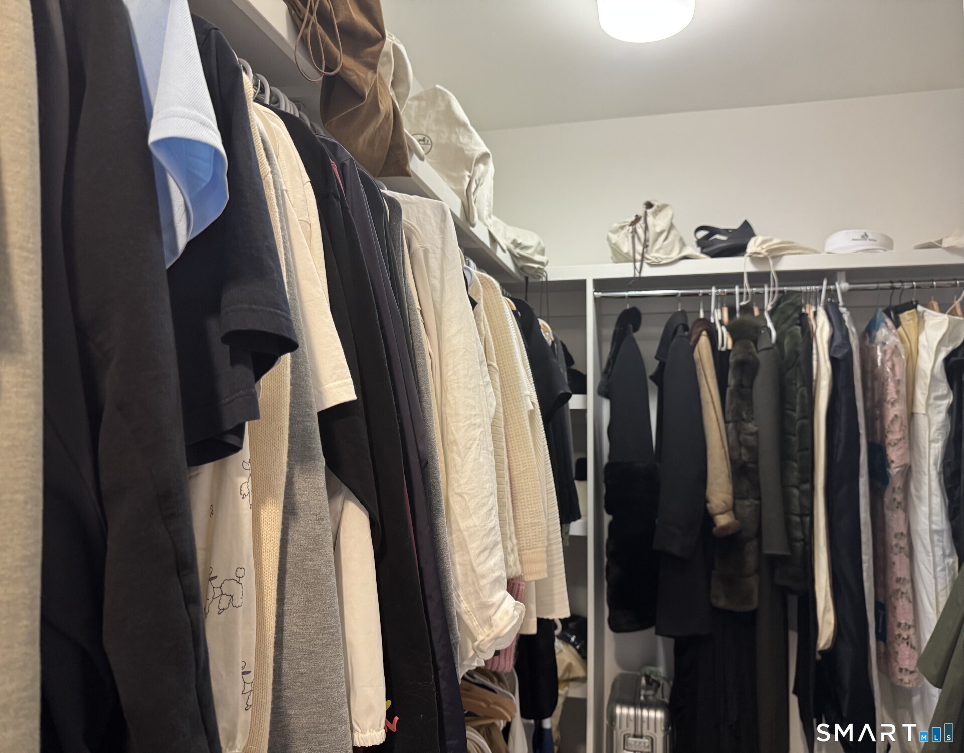 85 Memorial Road, Unit 201 West Hartford, CT 06107 - Photo 23 of 36 a view of walk in closet with clothes and shoes