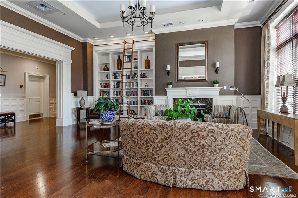85 Memorial Road, Unit 201 West Hartford, CT 06107 - Photo 6 of 36 a living room with furniture and a chandelier