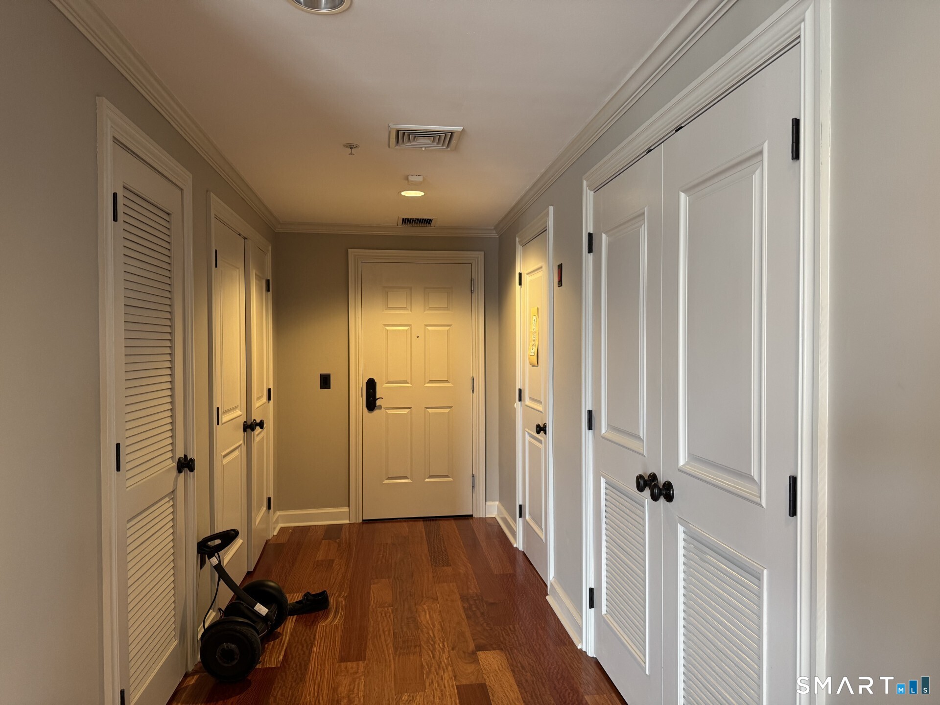 85 Memorial Road, Unit 201 West Hartford, CT 06107 - Photo 10 of 36 a view of a hallway with a hardwood floor and a livingroom