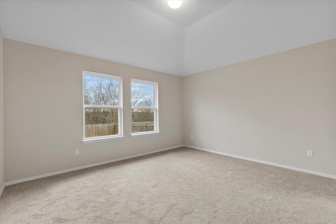 123 Saranac Drive Elgin, TX 78621 - Photo 13 of 26 The private primary bedroom offers a peaceful retreat at the end of the day.