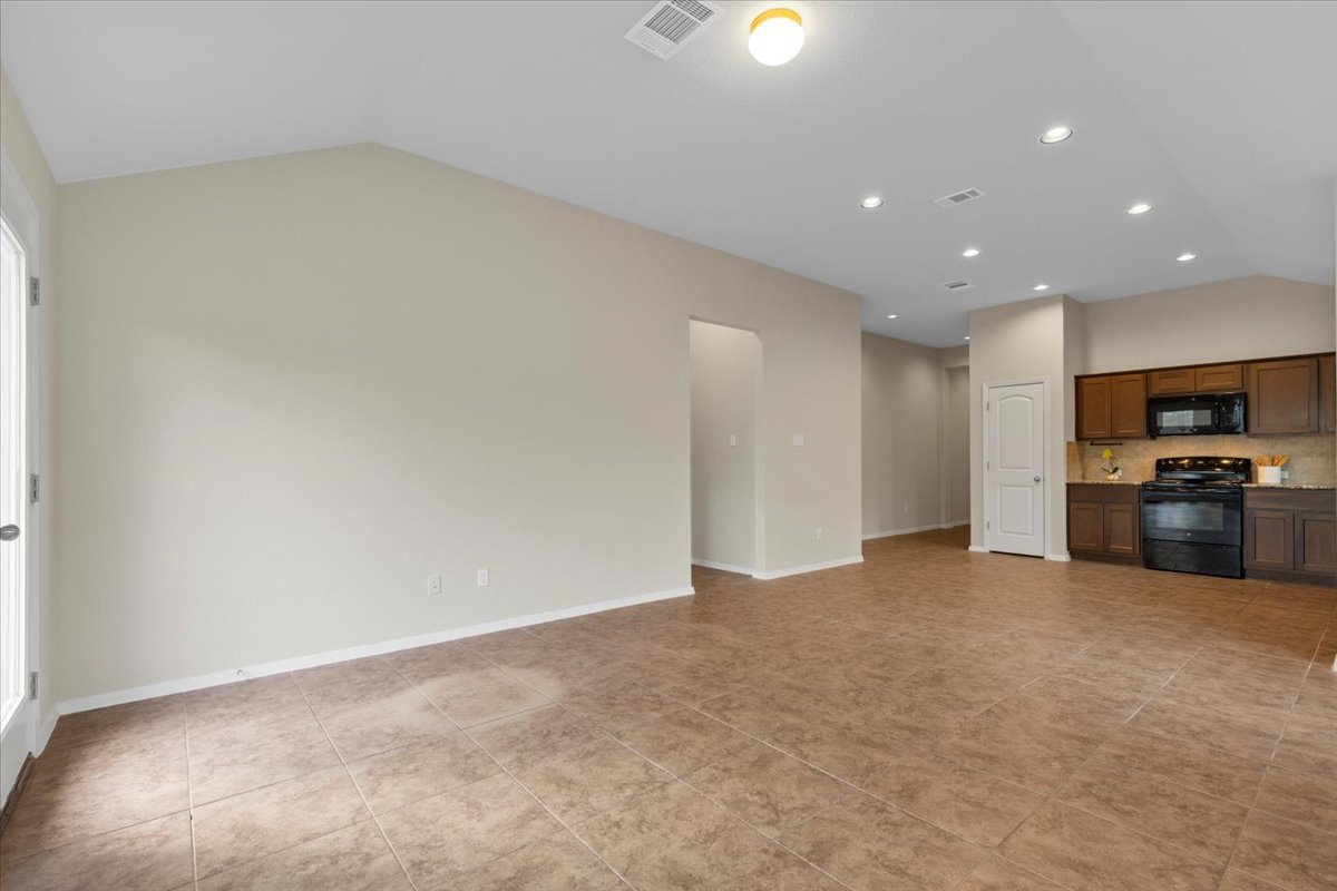 123 Saranac Drive Elgin, TX 78621 - Photo 5 of 26 a view of kitchen with refrigerator and microwave