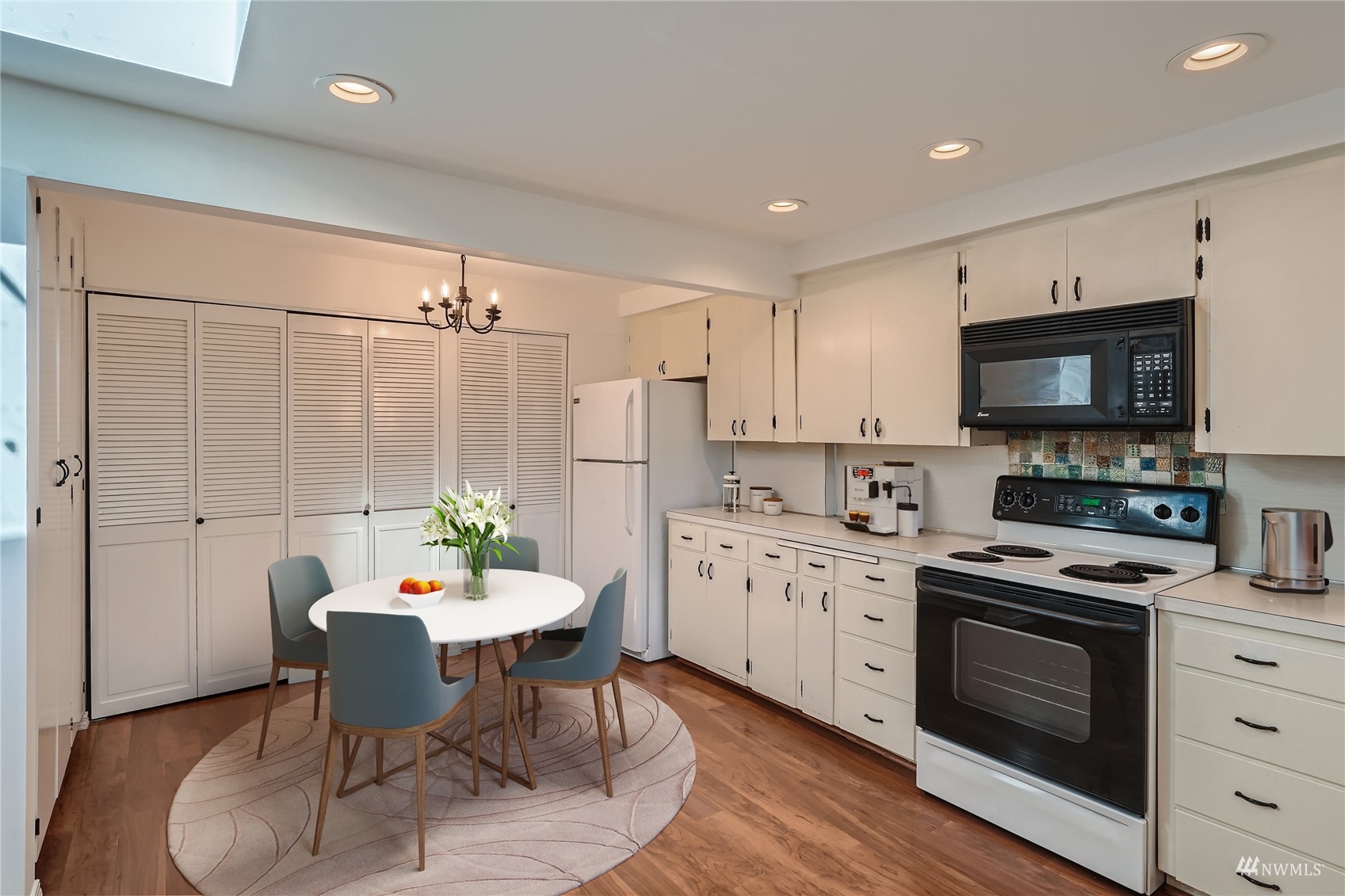 1109 North 30th Street Renton, WA 98056 - Photo 5 of 22 a kitchen with a dining table chairs and stainless steel appliances