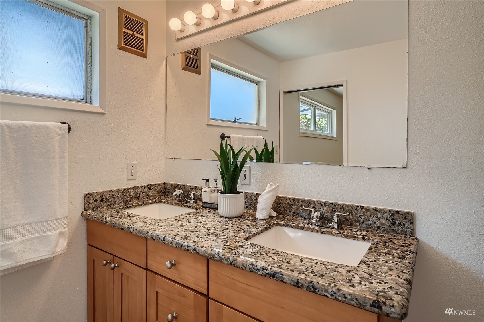 1109 North 30th Street Renton, WA 98056 - Photo 8 of 22 a bathroom with a granite countertop sink and a mirror