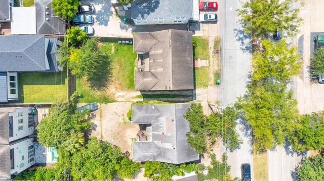 an aerial view of residential houses with yard