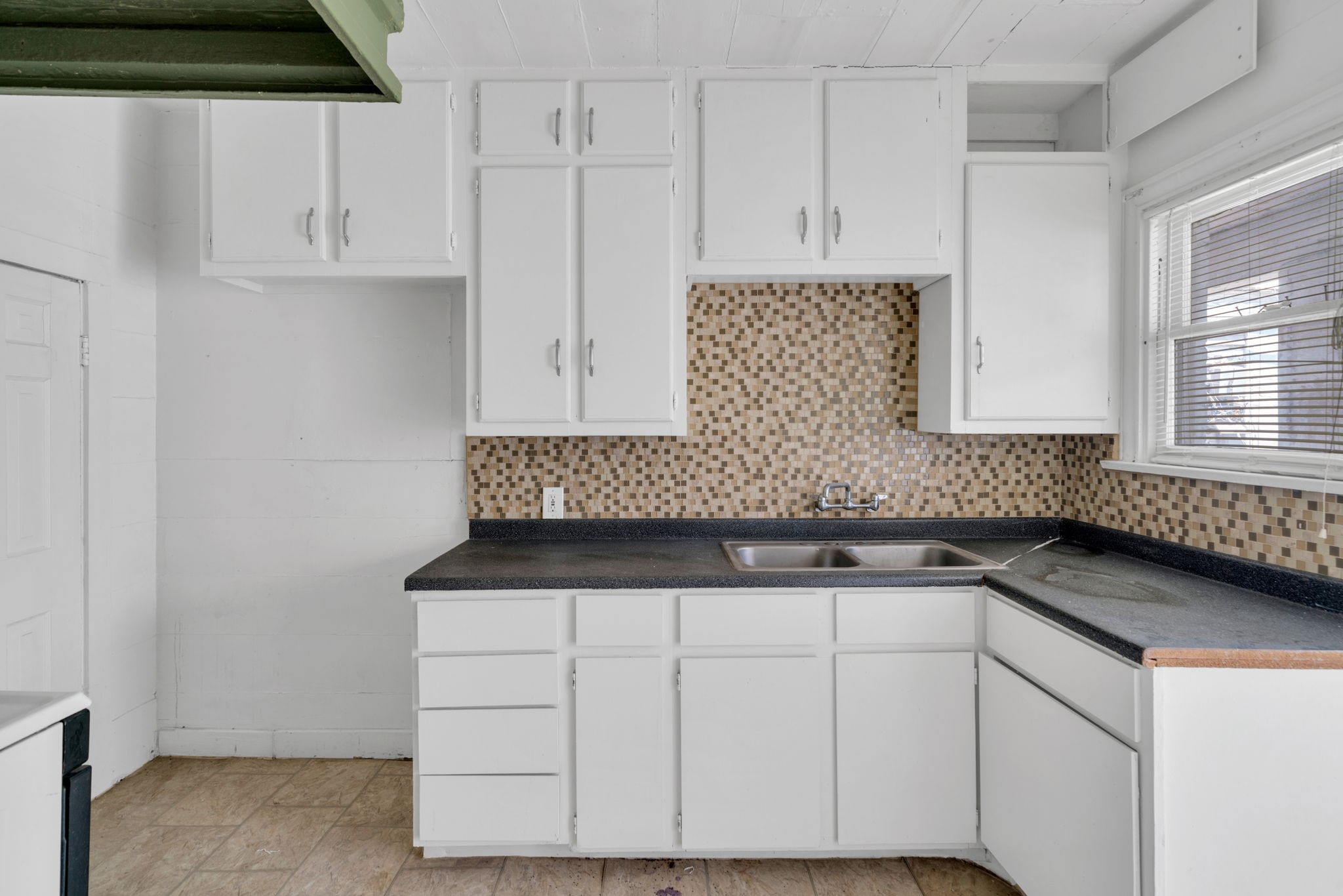1947 Richmond Avenue, Unit A Houston, TX 77098 - Photo 3 of 14 a kitchen with granite countertop white cabinets and sink