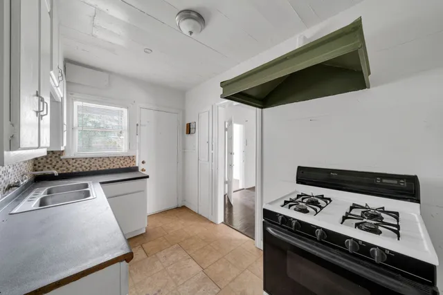 a kitchen with granite countertop a stove and a refrigerator