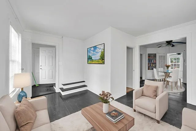 a living room with furniture and wooden floor