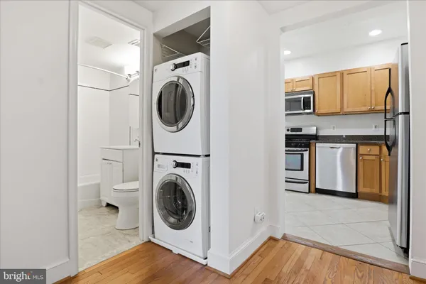 a view of a kitchen with stainless steel appliances granite countertop a sink and a stove top oven
