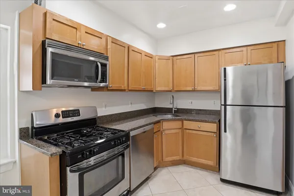 a kitchen with a stove microwave and refrigerator