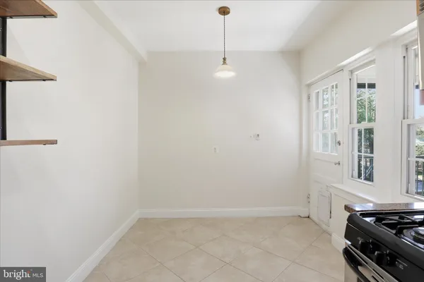 a view of a kitchen with an empty space and a window