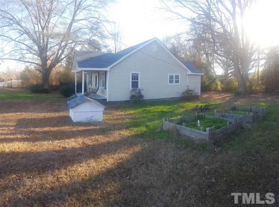 9716 Sauls Road Raleigh, NC 27603 - Photo 23 of 23 a view of a house with backyard and trees