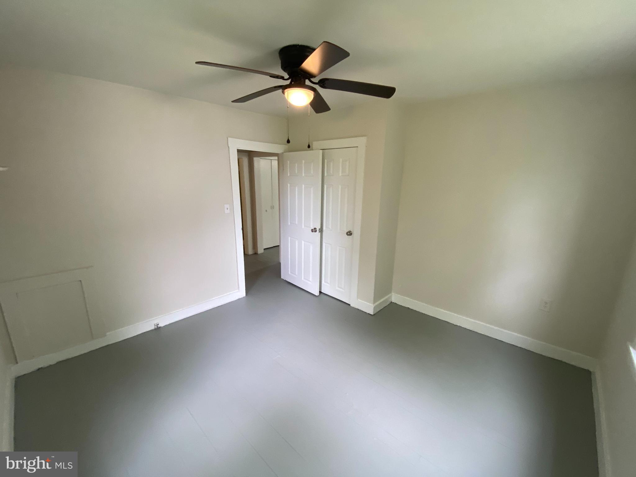 9067 St Anthonys Road King George, VA 22485 - Photo 11 of 24 an empty room with a ceiling fan and carpet