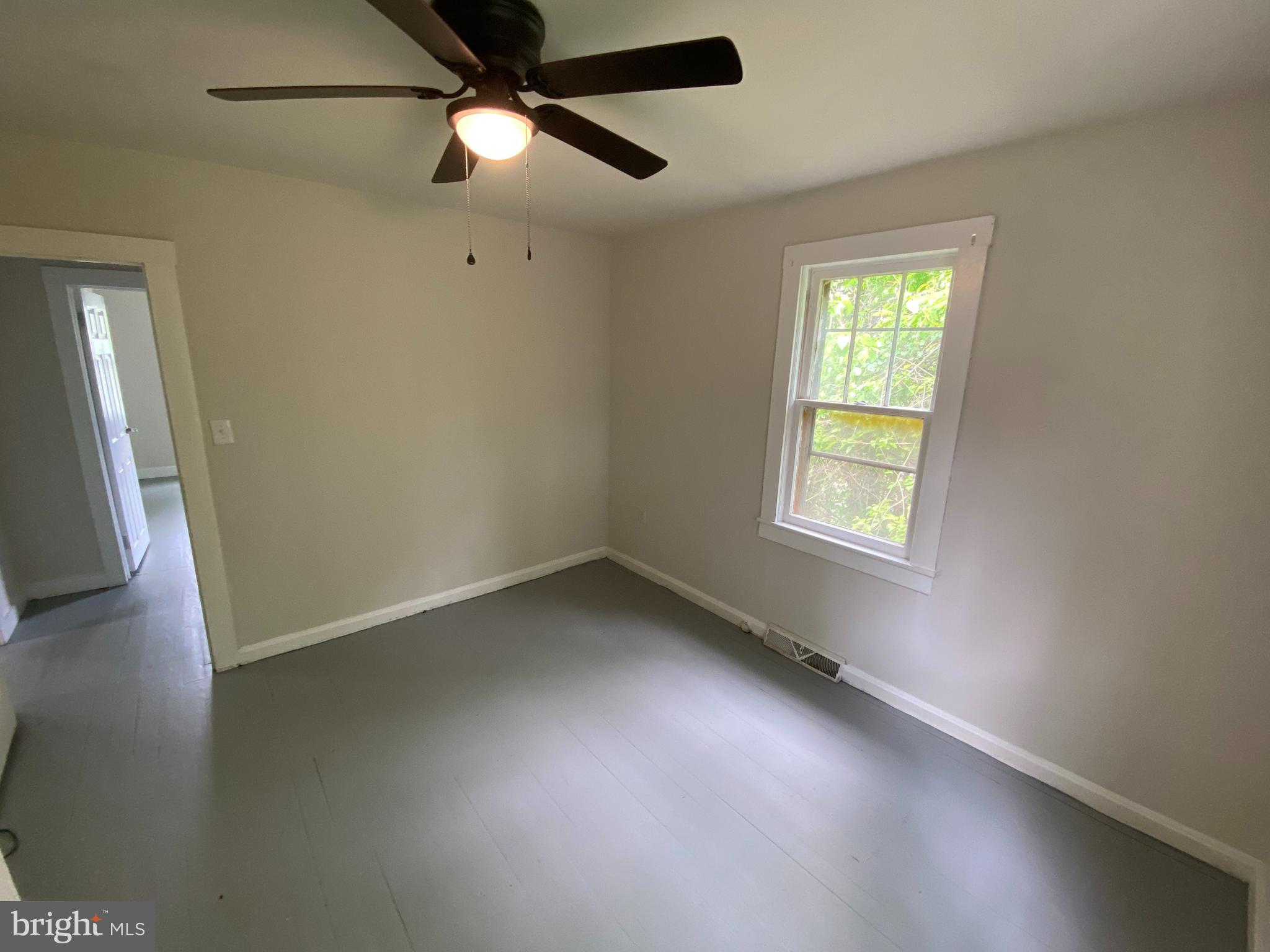9067 St Anthonys Road King George, VA 22485 - Photo 15 of 24 an empty room with a window and a ceiling fan