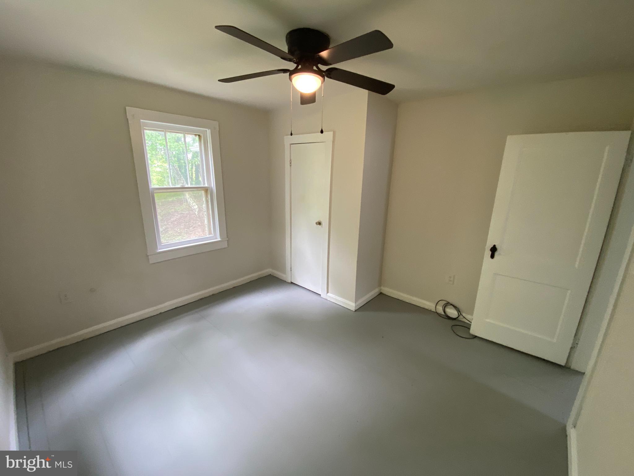 9067 St Anthonys Road King George, VA 22485 - Photo 17 of 24 an empty room with windows and fan