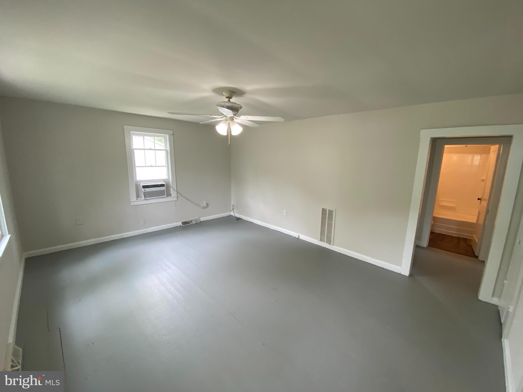 9067 St Anthonys Road King George, VA 22485 - Photo 2 of 24 wooden floor in an empty room with a window