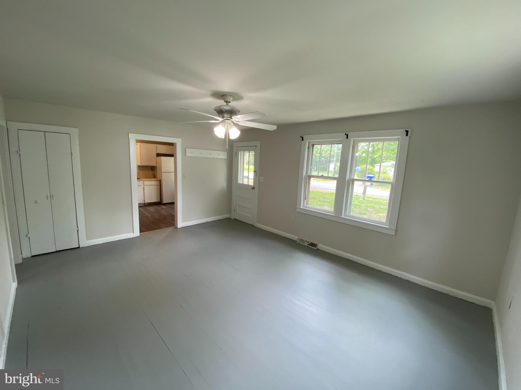 9067 St Anthonys Road King George, VA 22485 - Photo 4 of 24 an empty room with chandelier fan and windows