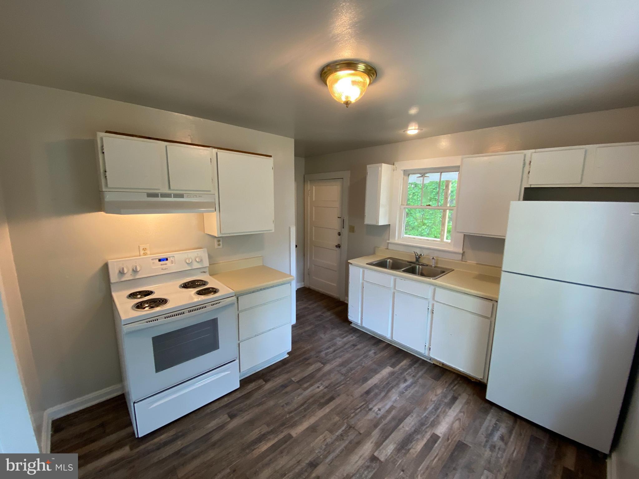 9067 St Anthonys Road King George, VA 22485 - Photo 6 of 24 a kitchen with a stove and a refrigerator