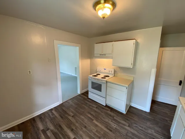 a room with a stove and wooden floor
