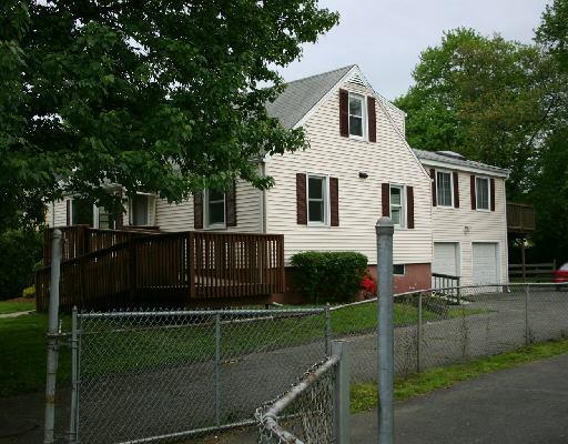 a front view of a house with plants