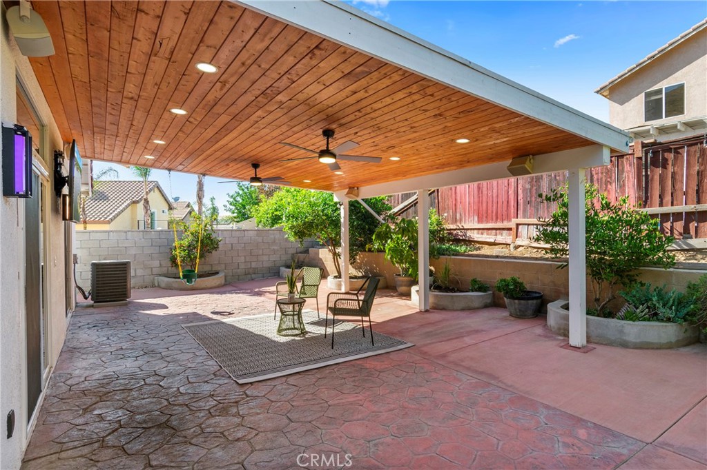 16366 West Sun Canyon Street Riverside, CA 92503 - Photo 20 of 21 a view of a patio with a table and chairs under an umbrella