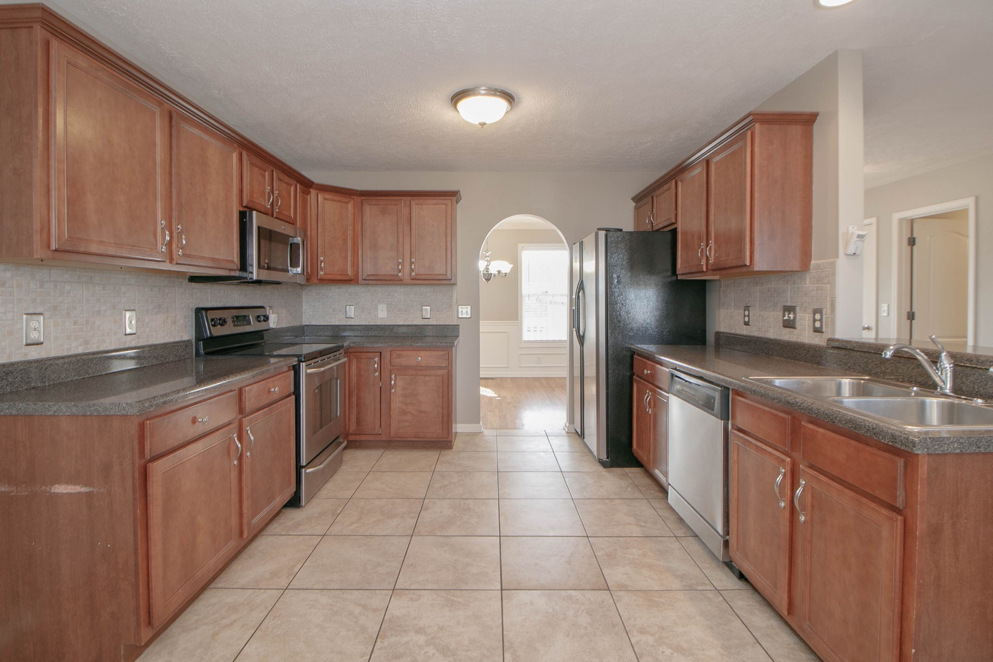 3147 Holly Point Clarksville, TN 37043 - Photo 13 of 46 a kitchen with stainless steel appliances granite countertop a sink counter space cabinets and a large window