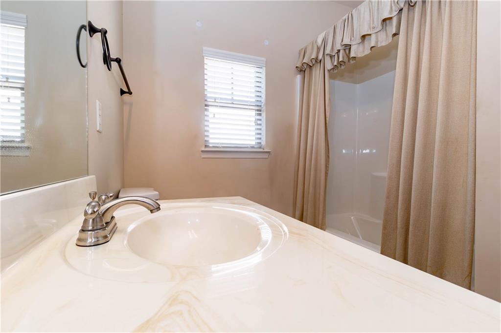 70 Sylvan Loop Fayetteville, GA 30214 - Photo 15 of 40 a bathroom with a sink and mirror